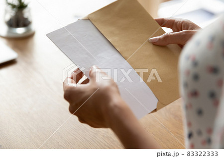 Hands of woman receiving letter, invitation, notification, postcard Hands of woman receiving letter, invitation, notification, postcard 83322333