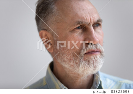 Close up thoughtful middle aged 60s man looking in distance. Close up thoughtful middle aged 60s man looking in distance. 83322693