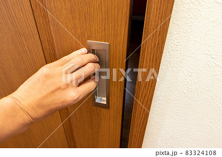 Open The Wooden Sliding Door By Hand Stock Photo