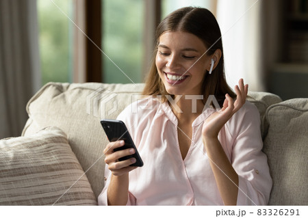 Happy girl with wireless earphone listening to radio music 83326291