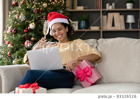 Happy young african american woman congratulating with holidays online. 83326526