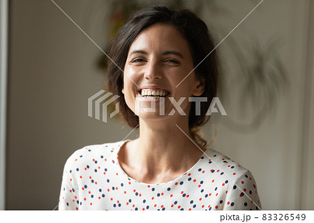Portrait of happy joyful woman looking and laughing at camera Portrait of happy joyful woman looking and laughing at camera 83326549