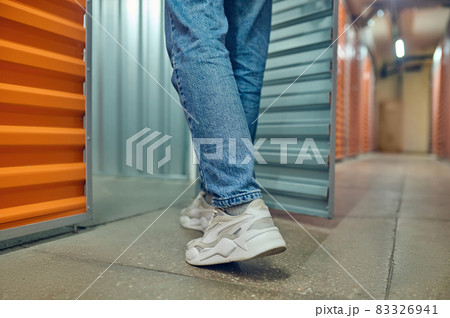 Legs of man entering open container door 83326941