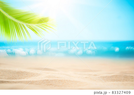 Blur beautiful nature green palm leaf on tropical beach with bokeh sun light wave abstract background. 83327409