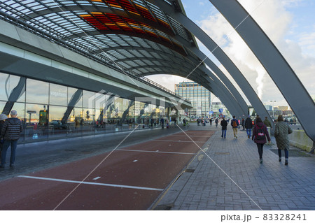 Amsterdam, Netherlands - Nov 30, 2019 : Passengers taking bus at the bus terminal station in the Amsterdam Centraal in Amsterdam, Netherlands on Nov 30, 2019. Amsterdam, Netherlands - Nov 30, 2019 : Passengers taking bus at the bus terminal station in the Amsterdam Centraal in Amsterdam, Netherlands on Nov 30, 2019. 83328241
