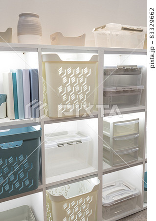 Plastic container boxes on a shelf on a rack for organizing home space and storing things, order and interior, selling household goods. Industrial background 83329662
