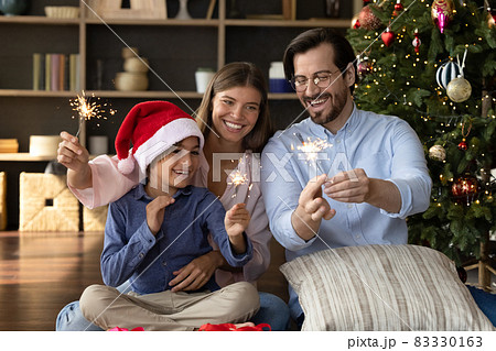 Happy festive couple parents and small son celebrating New Year. 83330163