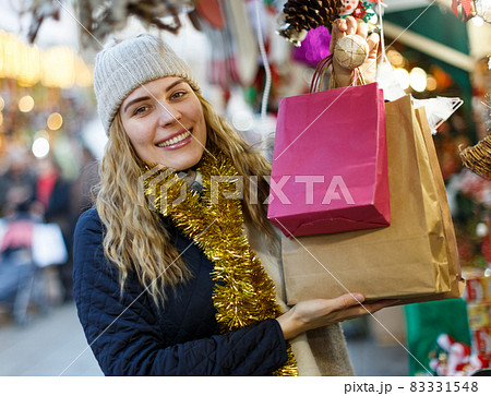 Cheerful girl near Christmas fair shops Cheerful girl near Christmas fair shops 83331548