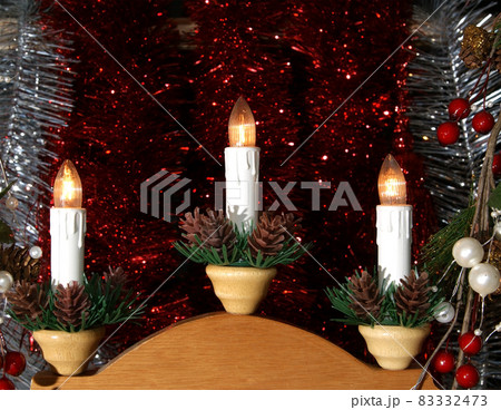 New Year's electric candles on the background of Christmas decorations New Year's electric candles on the background of Christmas decorations 83332473