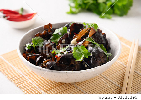 Salad of chinese pickled tree black muer mushrooms with chilli pepper and coriander leaves in bowl. Salad of chinese pickled tree black muer mushrooms with chilli pepper and coriander leaves in bowl. 83335395