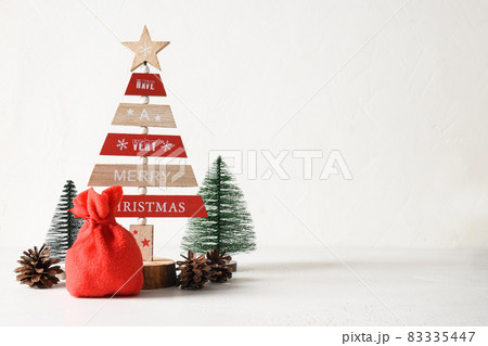 Creative wooden Eco Christmas tree and pine cones on white background. DIY. 83335447