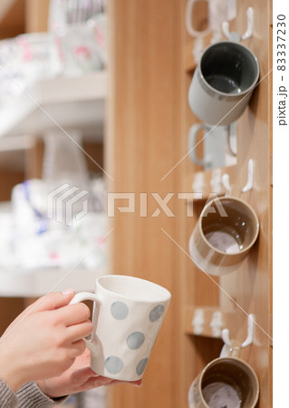 Person choosing new kitchenware in the shopping mall Person choosing new kitchenware in the shopping mall 83337230