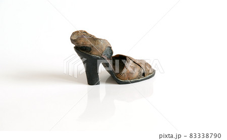 Old ceramic shoes isolated on white background Old ceramic shoes isolated on white background 83338790