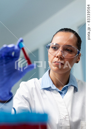 Scientist doctor holding blood vacutainer analyzing during biochemistry experiment 83339564