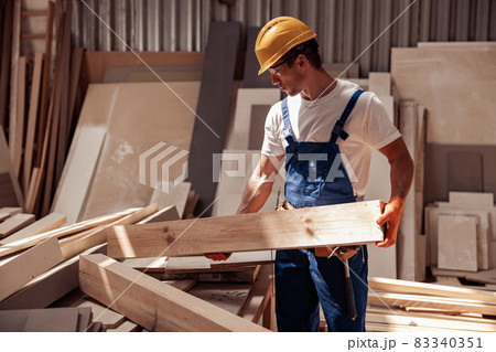 Handsome young man working in carpentry workshop Handsome young man working in carpentry workshop 83340351