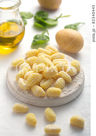 Raw italian gnocchi on a white background with potato and olive oil 83340445