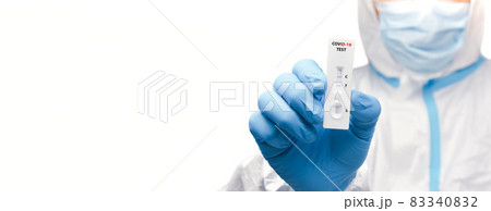 The hand of a medical professional displaying a positive covid-19 test result, horizontal copy space The hand of a medical professional displaying a positive covid-19 test result, horizontal copy space 83340832