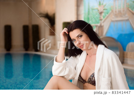 Girl in bikini near the pool. Beauty Treatment. Wellness. Healthy Lifestyle Concept. Girl in bikini near the pool. Beauty Treatment. Wellness. Healthy Lifestyle Concept. 83341447