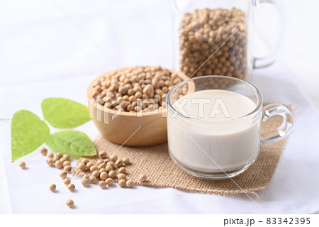 Soy milk in a cup glass and soy beans in a bowl on white background, Healthy drink Soy milk in a cup glass and soy beans in a bowl on white background, Healthy drink 83342395