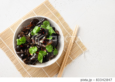 Salad of chinese pickled tree black muer mushrooms in bowl on white background. Salad of chinese pickled tree black muer mushrooms in bowl on white background. 83342847
