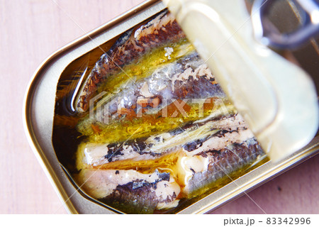 open tin of sardines on white tiles background. open tin of sardines on white tiles background. 83342996