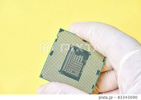 Macro-shot of computer microchip processor. Global chip and semiconductor shortage. Symbol of ongoing crisis in car industry. Concept of high demand for integrated circuits 83343090