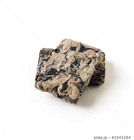Chinese dry pressed tree black muer mushroom in briquette isolated on white background. Chinese dry pressed tree black muer mushroom in briquette isolated on white background. 83343284