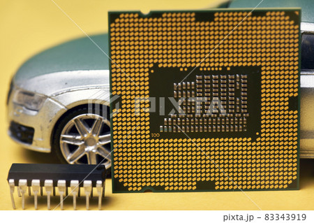 CPU chip and semiconductors with car toy. Global car chip shortage. Micro-chip shortage creates dearth of new cars. Computer chip shortage stalls car industry production CPU chip and semiconductors with car toy. Global car chip shortage. Micro-chip shortage creates dearth of new cars. Computer chip shortage stalls car industry production 83343919