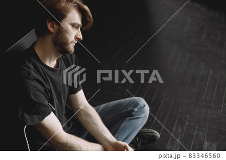 Male druggy sitting relaxed after taking dose 83346560