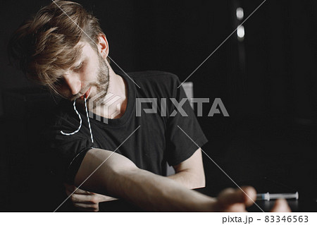 Drug addict injecting heroin into arm Drug addict injecting heroin into arm 83346563