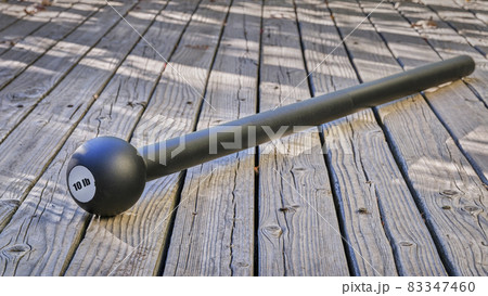 steel mace (or macebell) on a wooden deck 83347460