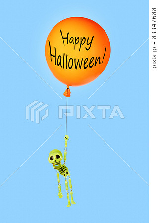 Bright Halloween greeting card with funny green toy plastic skeleton flying on orange balloon with black inscription Happy Halloween on blue background. Trick or treat. Vertical orientation of shot. Bright Halloween greeting card with funny green toy plastic skeleton flying on orange balloon with black inscription Happy Halloween on blue background. Trick or treat. Vertical orientation of shot. 83347688