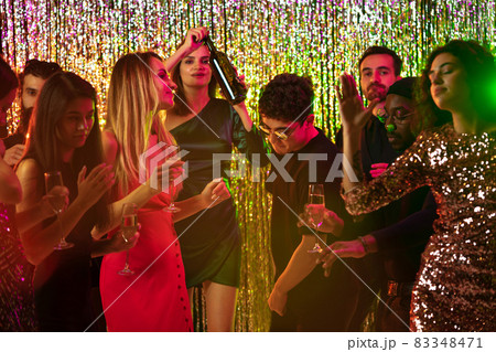 Group of friends at the party, dancing, laughing. New Year celebration Group of friends at the party, dancing, laughing. New Year celebration 83348471