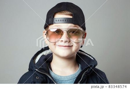 Funny little boy in glasses and cap. stylish smiling kid 83348574