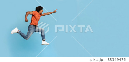 Excited black guy running towards copy space Excited black guy running towards copy space 83349476
