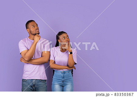 Pensive black couple looking aside at free copy space, thinking Pensive black couple looking aside at free copy space, thinking 83350367