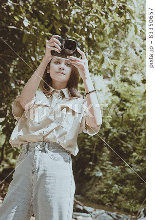 Series photo of young woman photographer with her camera shooting photo outdoor 83350657