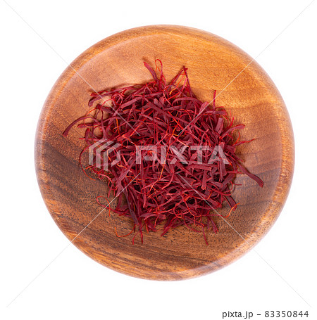 Saffron in wooden bowl, isolated on white background. Natural dry saffron threads, from crocus flowers. Clipping path. Top view. Saffron in wooden bowl, isolated on white background. Natural dry saffron threads, from crocus flowers. Clipping path. Top view. 83350844