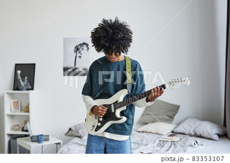 African American Teenager Playing Guitar at Home African American Teenager Playing Guitar at Home 83353107
