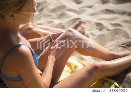 Close-up of woman applying sunscreen Close-up of woman applying sunscreen 83360590