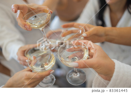 Celebration. People holding glasses of white wine making a toast. 83361445