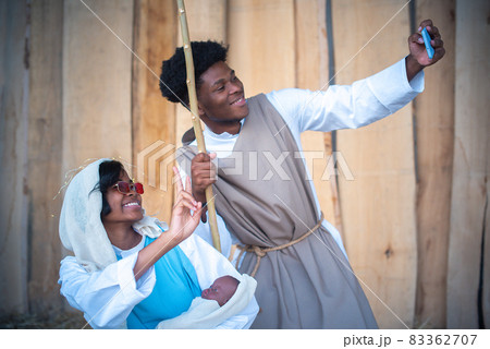 Modern nativity scene representation with black characters taking a selfie Modern nativity scene representation with black characters taking a selfie 83362707