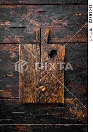 Empty wooden cutting board, top view flat lay , with copy space for text or food, on old dark wooden table background Empty wooden cutting board, top view flat lay , with copy space for text or food, on old dark wooden table background 83363941