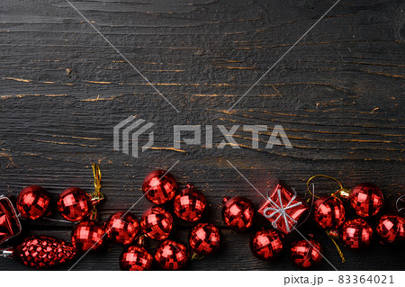 Christmas decorations and objects, top view flat lay, on black wooden table background, with copy space for text 83364021