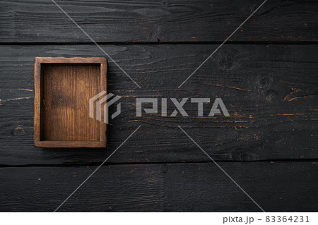 Empty dark wooden box with copy space for text or food, top view flat lay , on black wooden table background 83364231
