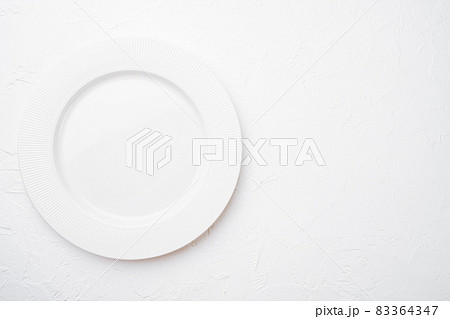 Ceramic empty white plate with copy space for text or food with copy space for text or food, top view flat lay , on white stone table background Ceramic empty white plate with copy space for text or food with copy space for text or food, top view flat lay , on white stone table background 83364347