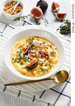 Pumpkin soup with feta, figs, pine nuts, top view 83365482
