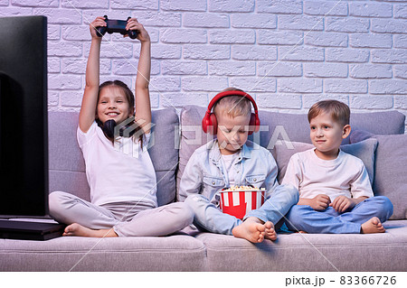 children playing video game with game console children playing video game with game console 83366726