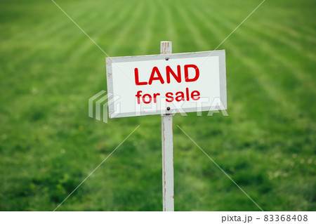 land for sale sign against trimmed lawn background land for sale sign against trimmed lawn background 83368408