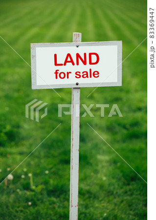 land for sale sign against trimmed lawn background 83369447